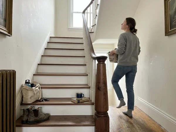 Continuous walnut handrail with gooseneck over a new newel post