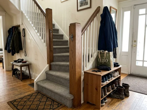 Modern square newel post standing plumb with the original handrail