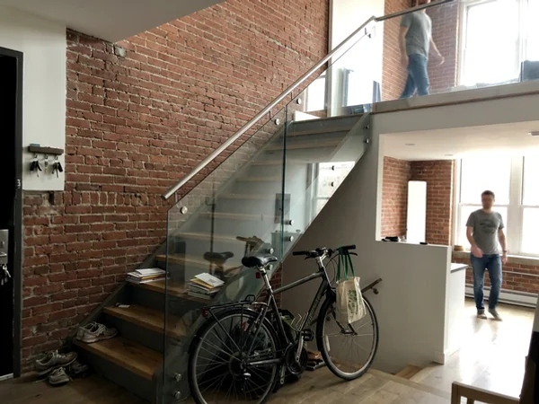Same loft staircase after frameless glass railing install