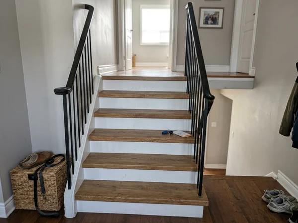 Same staircase after oak-look vinyl capping with white risers