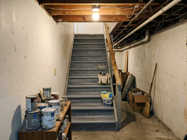 Basement rental staircase finished with waterproof grey vinyl treads
