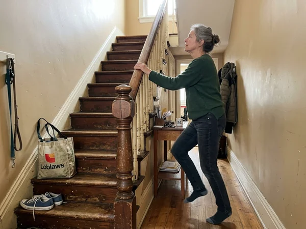 Loose pine handrail and cracked newel post before replacement