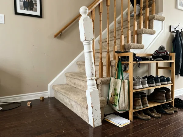 Leaning builder-grade newel post before replacement
