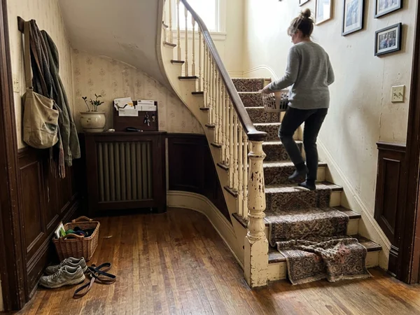Worn curved staircase in a Rosedale Edwardian home before renovation