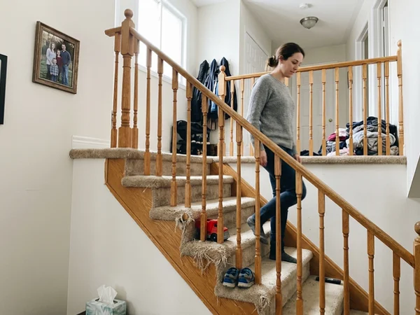 Carpeted builder-grade staircase before hardwood recapping