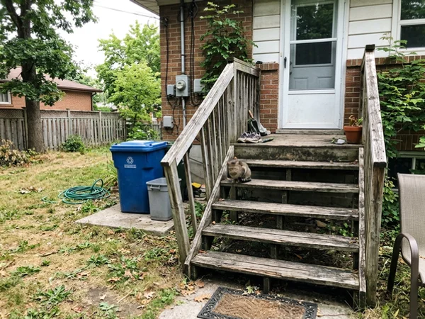 Rotted back steps with a sagging stringer before the rebuild