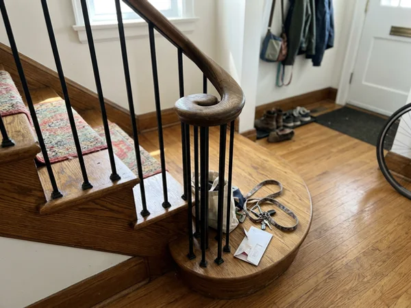 Oak volute on a curved handrail above a starting step
