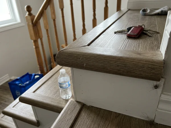 Close-up of a vinyl bullnose stair nose and riser joint