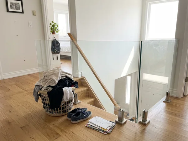 Semi-frameless glass railing with spigots along a landing