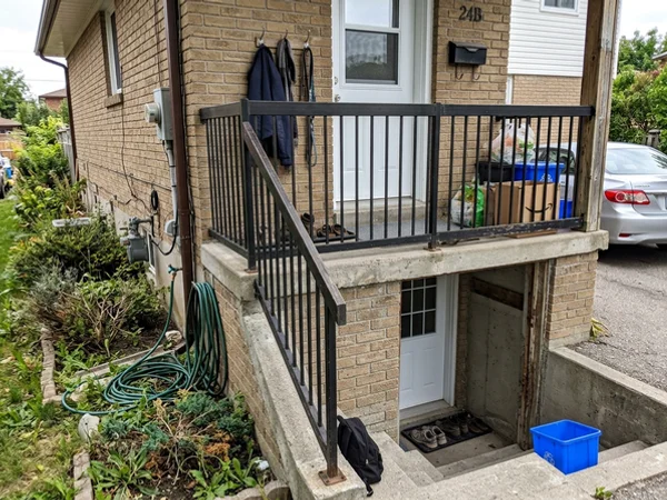 Second-suite basement stair with a guard and non-slip treads