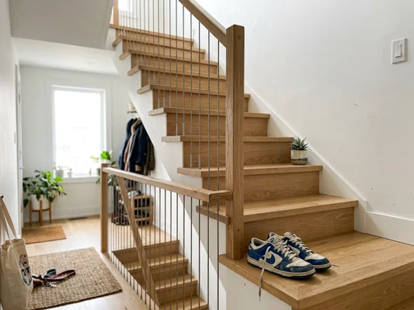Vertical stainless cable railing on white oak treads